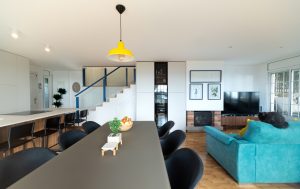 Cocina abierta al salón con suelo colorido y vistas al mar en Sitges.