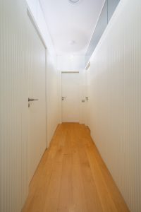 Vista general del pasillo del Proyecto Mallorca con iluminación cuidada y continuidad material.